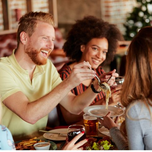 Group of young adults enjoying a meal together