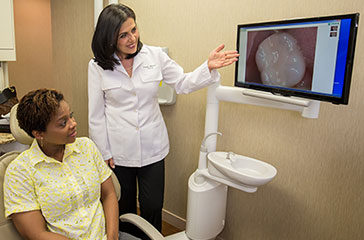 Doctor Alidadi showing patient computer rendition of tooth.